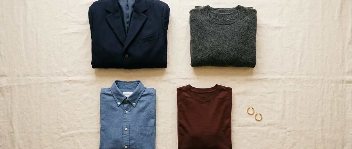 Flat lay of headshot outfits: blazer, sweaters and shirts
