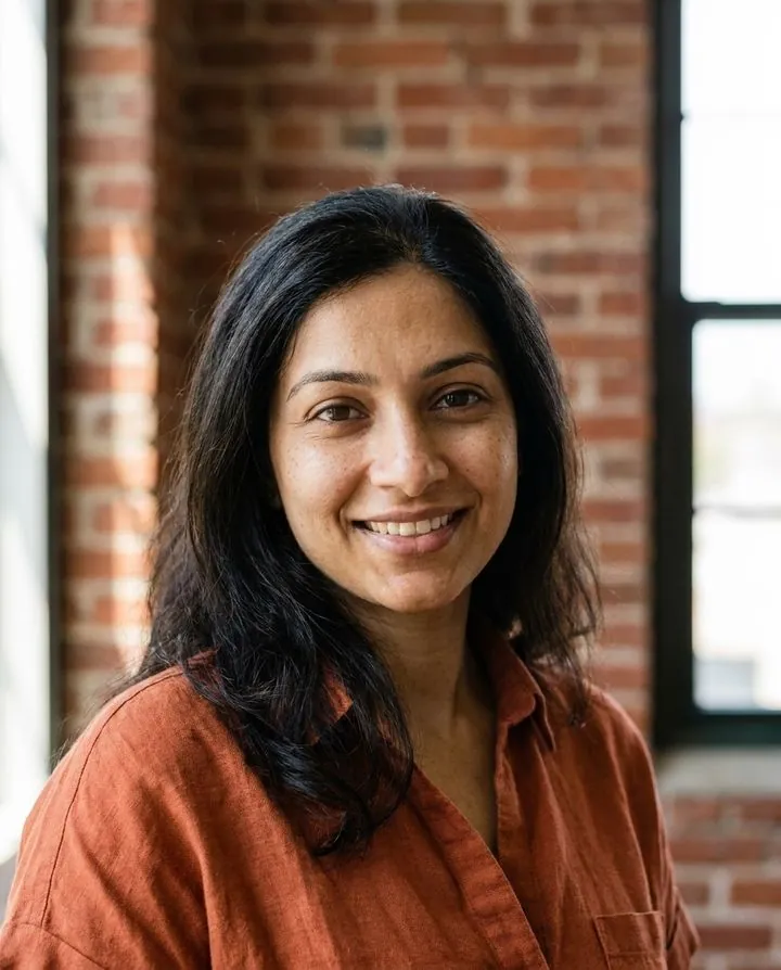 Creative AI profile picture: rust shirt in front of an exposed brick wall