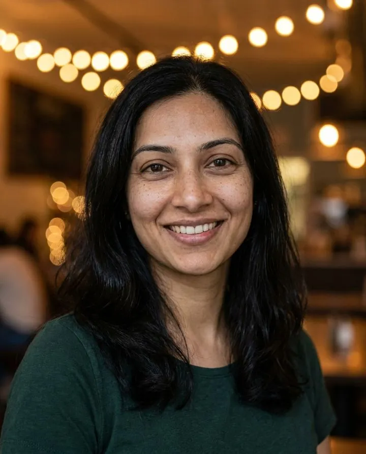 Dating profile AI picture: green top in a warm café with string lights