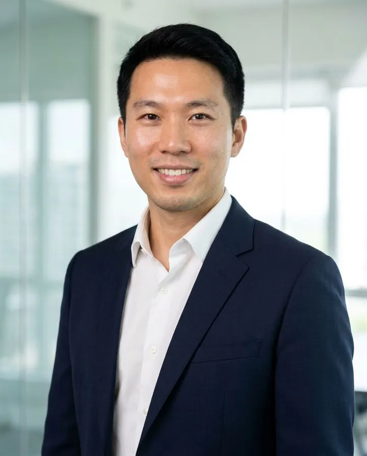 AI headshot in a navy suit in a bright glass office